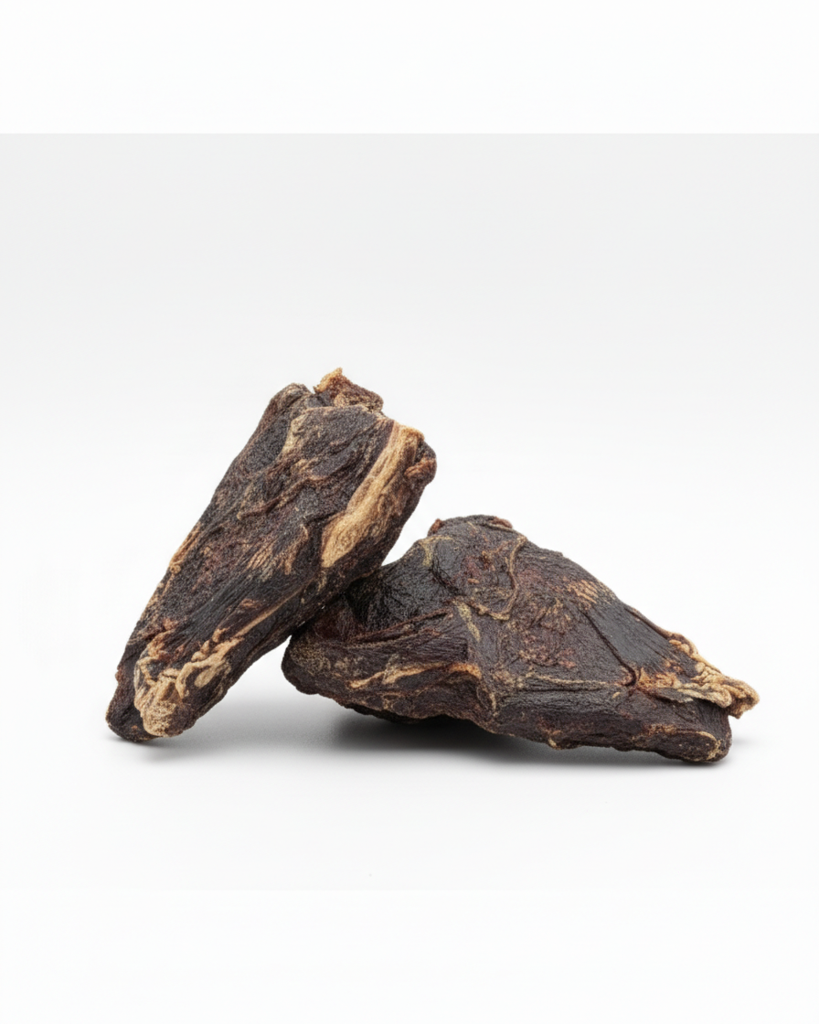 Two dehydrated pig heart dog chews on a white background